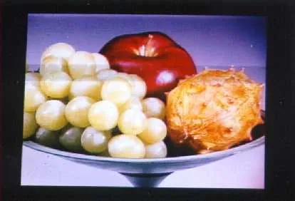 A full-color laser-projected still life of fruit in a bowl.